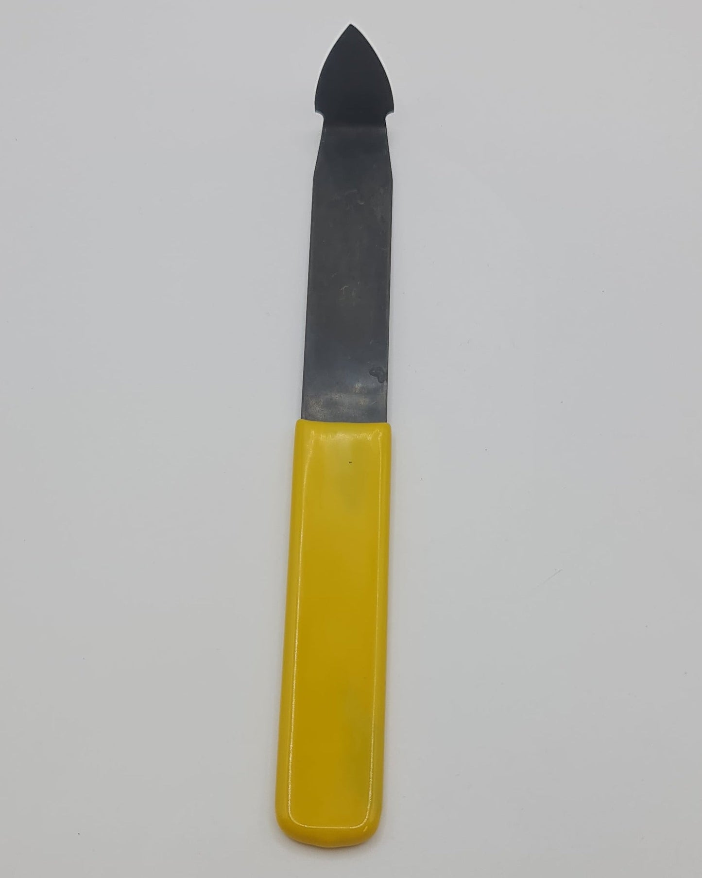 Yellow handled trimming tool for the pottery wheel.