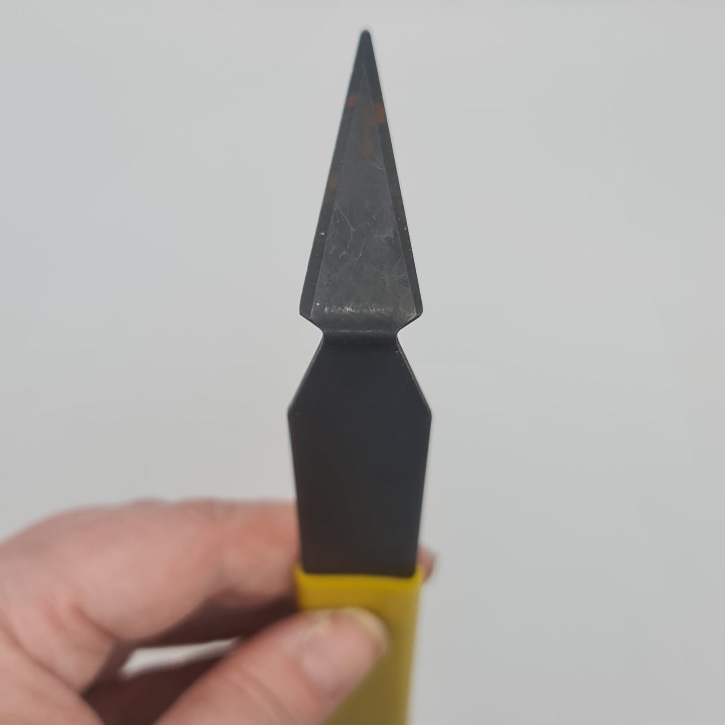 Yellow handled triangle turning tool for the pottery wheel.