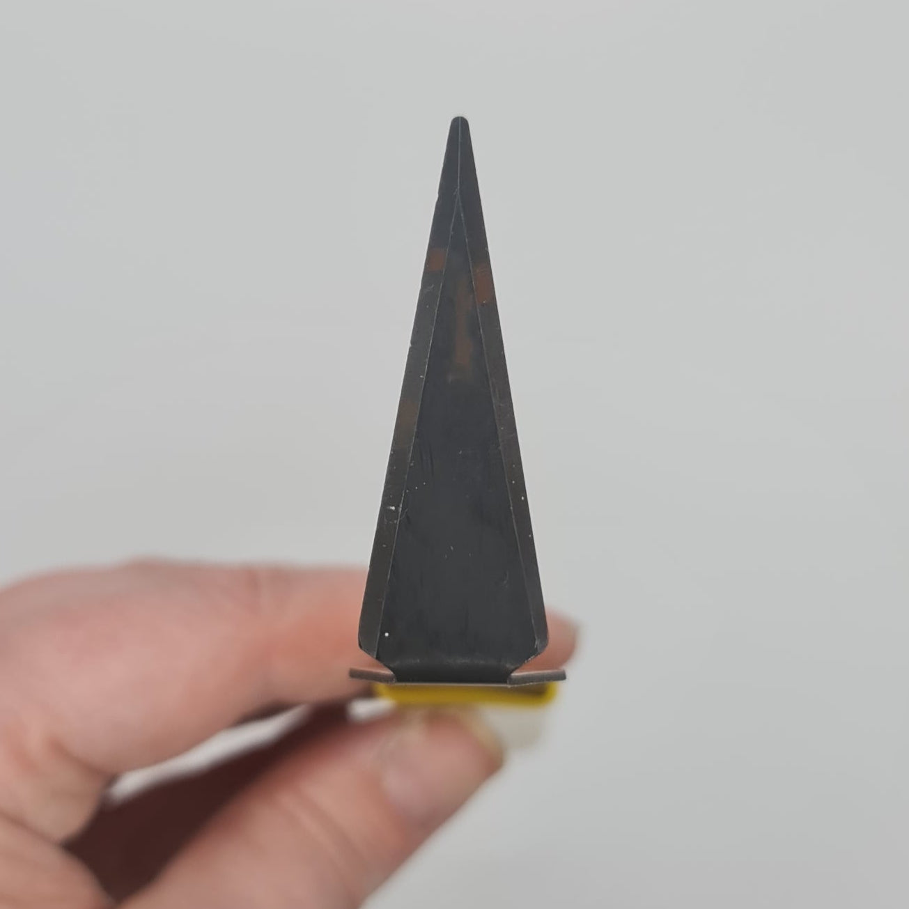 Yellow handled triangle turning tool for the pottery wheel.